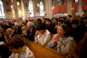 People attend the funeral mass for Cardinal Aloysius Ambrozic at St. Michael's Catholic Cathedral